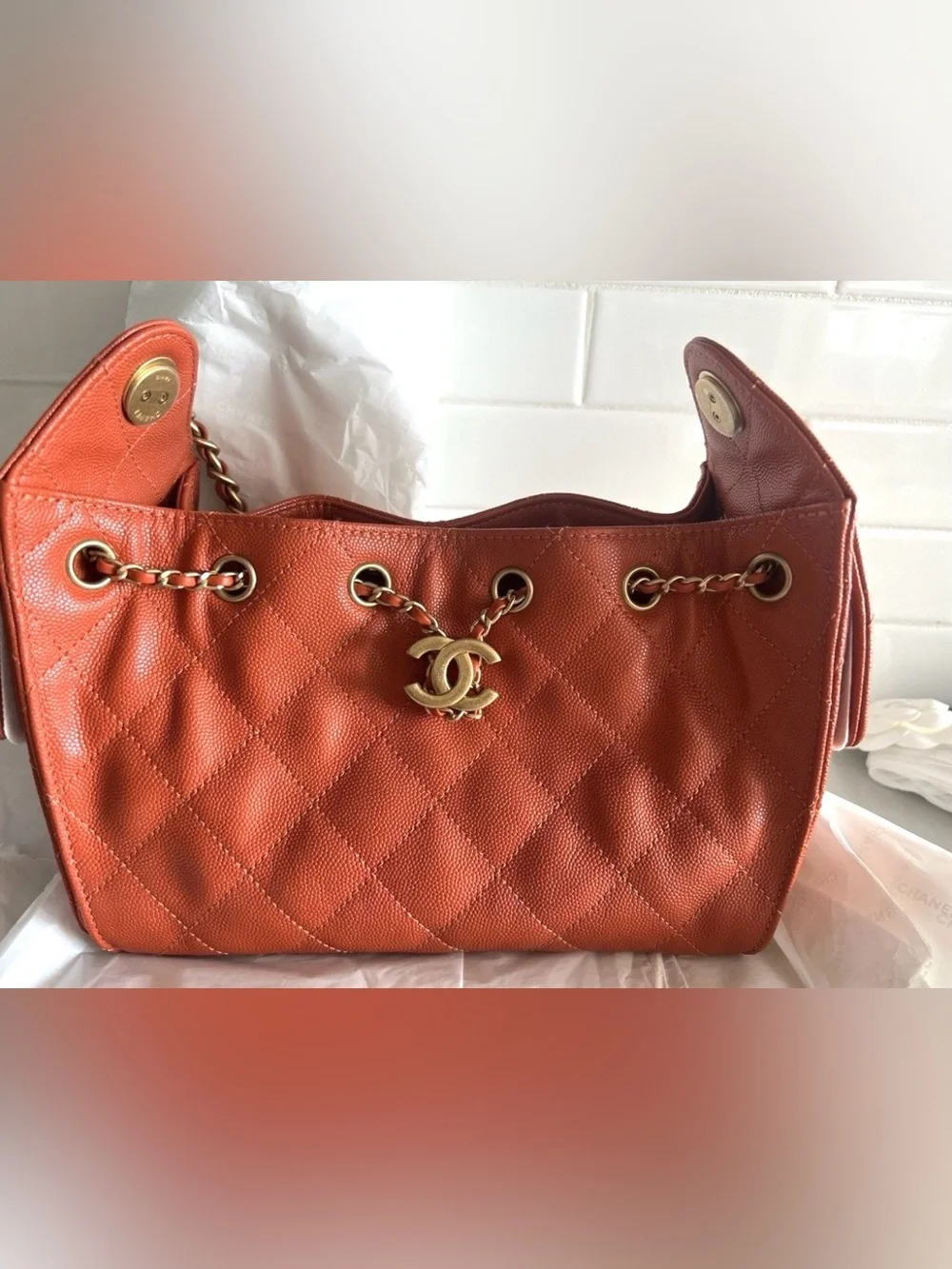 CHANEL Orange Quilted Drawstring Shoulder Bag with Gold Chain